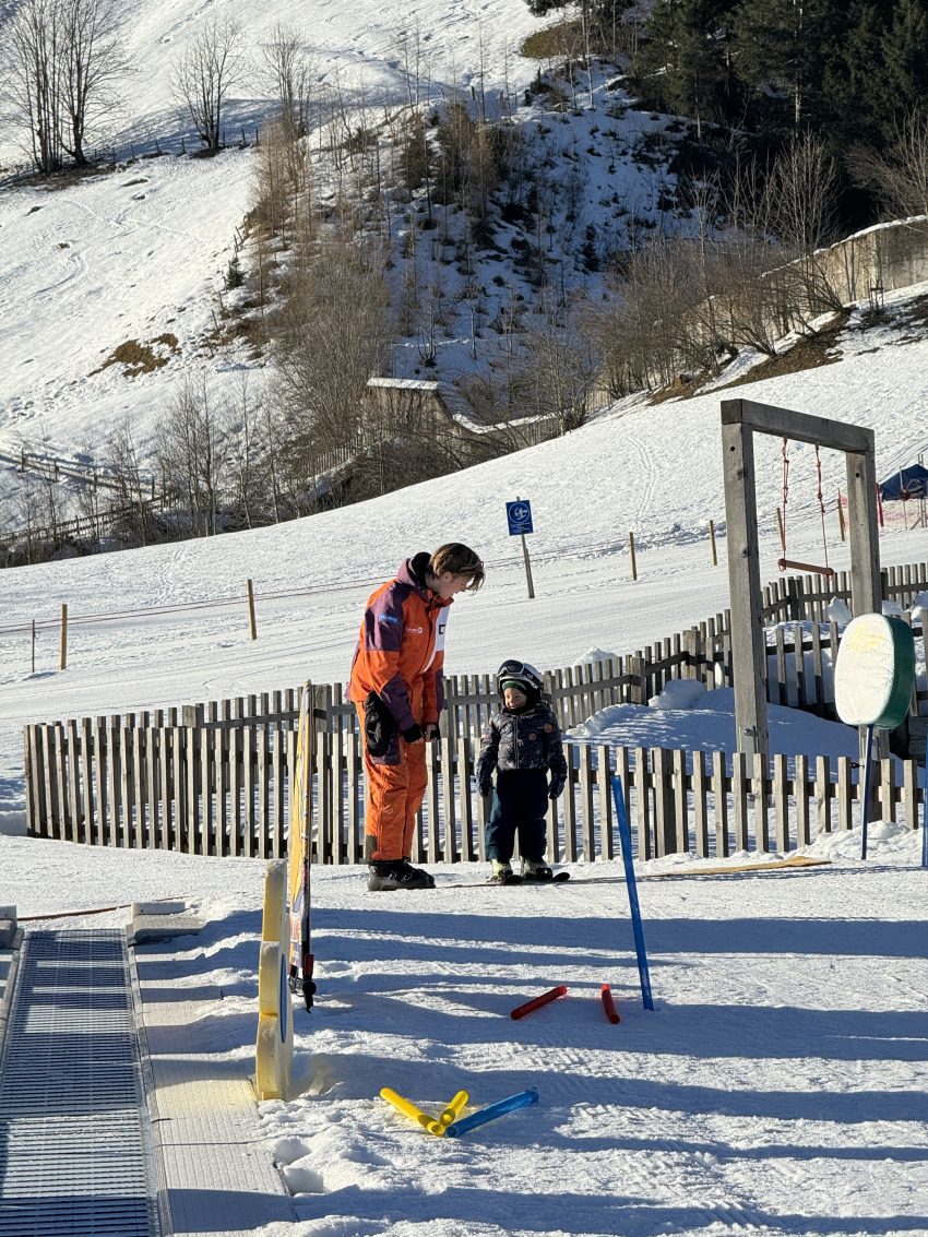 2 year old taking a ski lesson